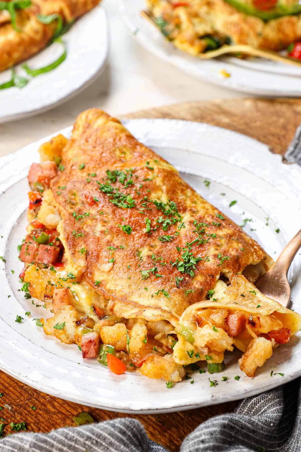 taking a bite of omelette recipe showing how fluffy it is
