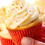 holding up a vanilla cupcakes cupcake showing the frosting